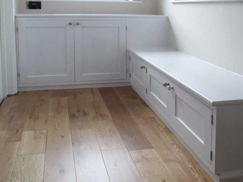 White wooden cupboard seat in hall