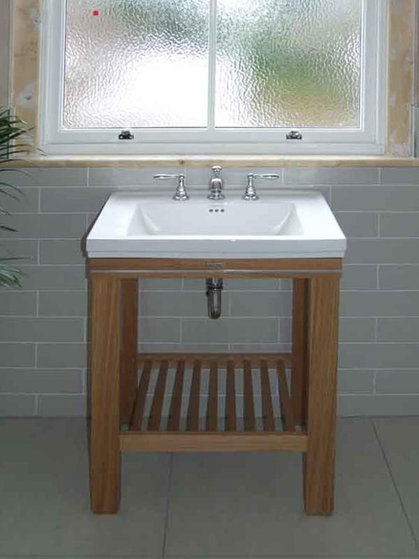 Bathroom sink with oak stand and grey tiles
