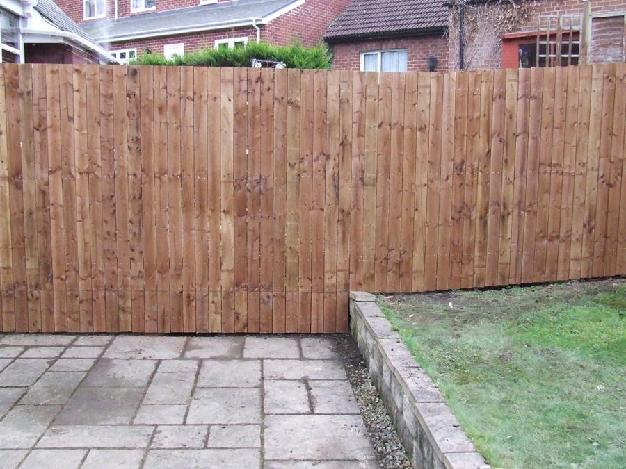 Timber fence and paved yard