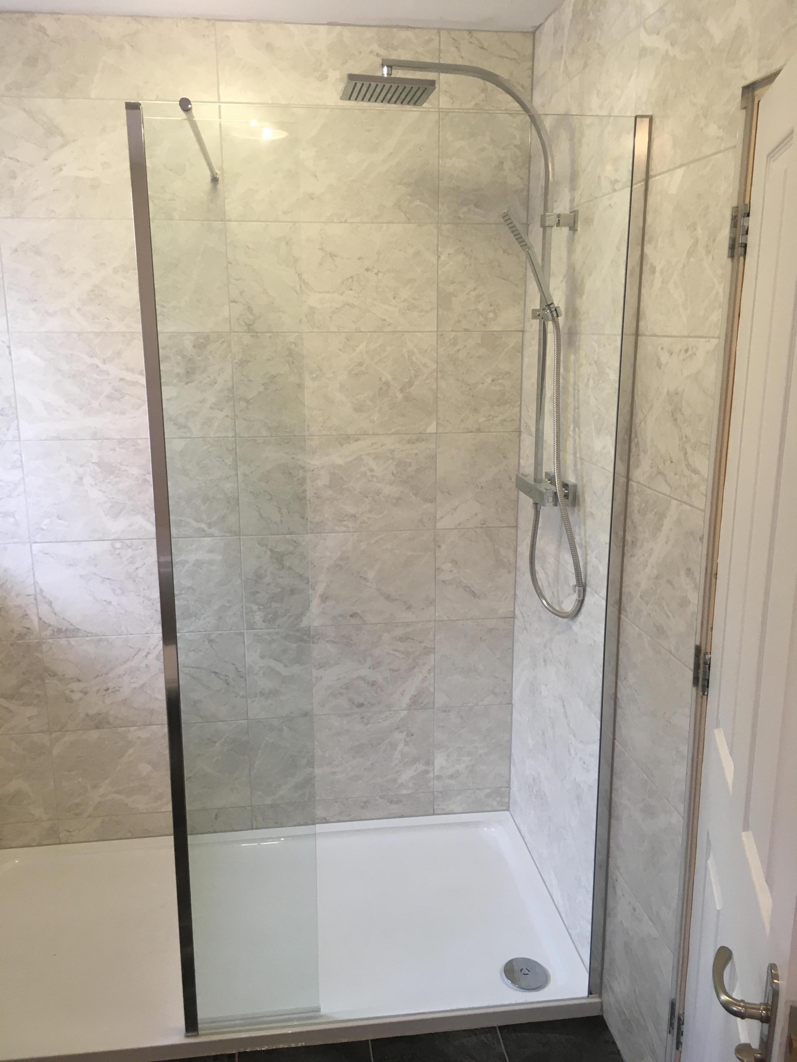 Clear glass walk in level floor shower enclosure
