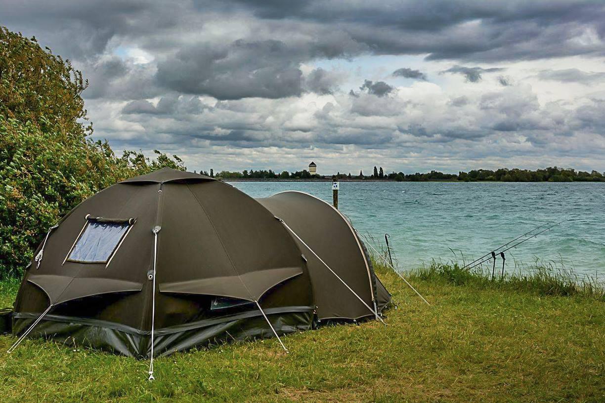 Karsten Inflatable Carp Bivvy pitched at the waters edge with rod out front