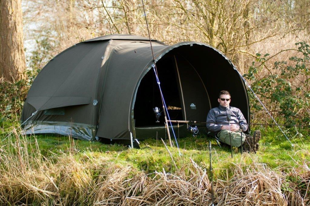 Karsten Inflatable Bivvy with Comfort Awning and man sitting out under it.