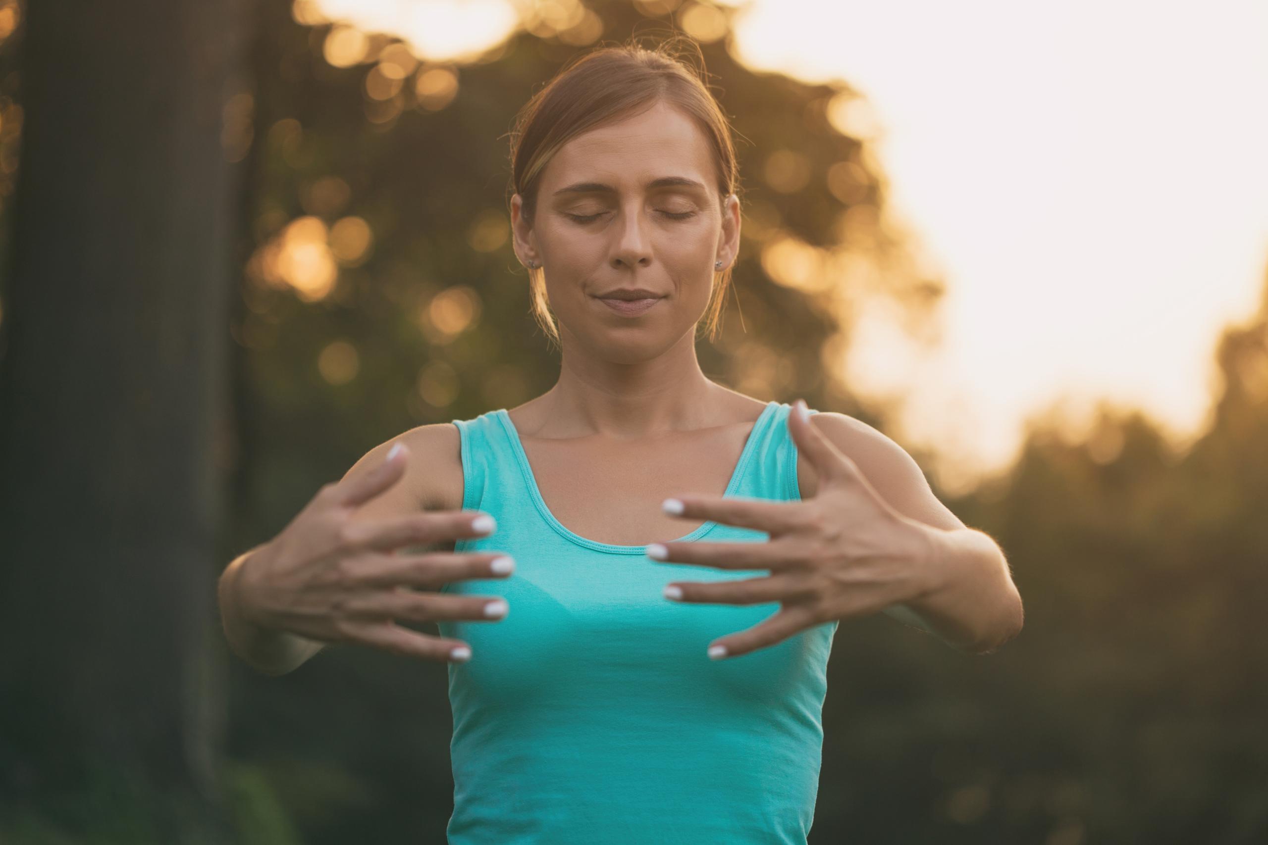 Photo of Wendy practising qigong in a studio setting