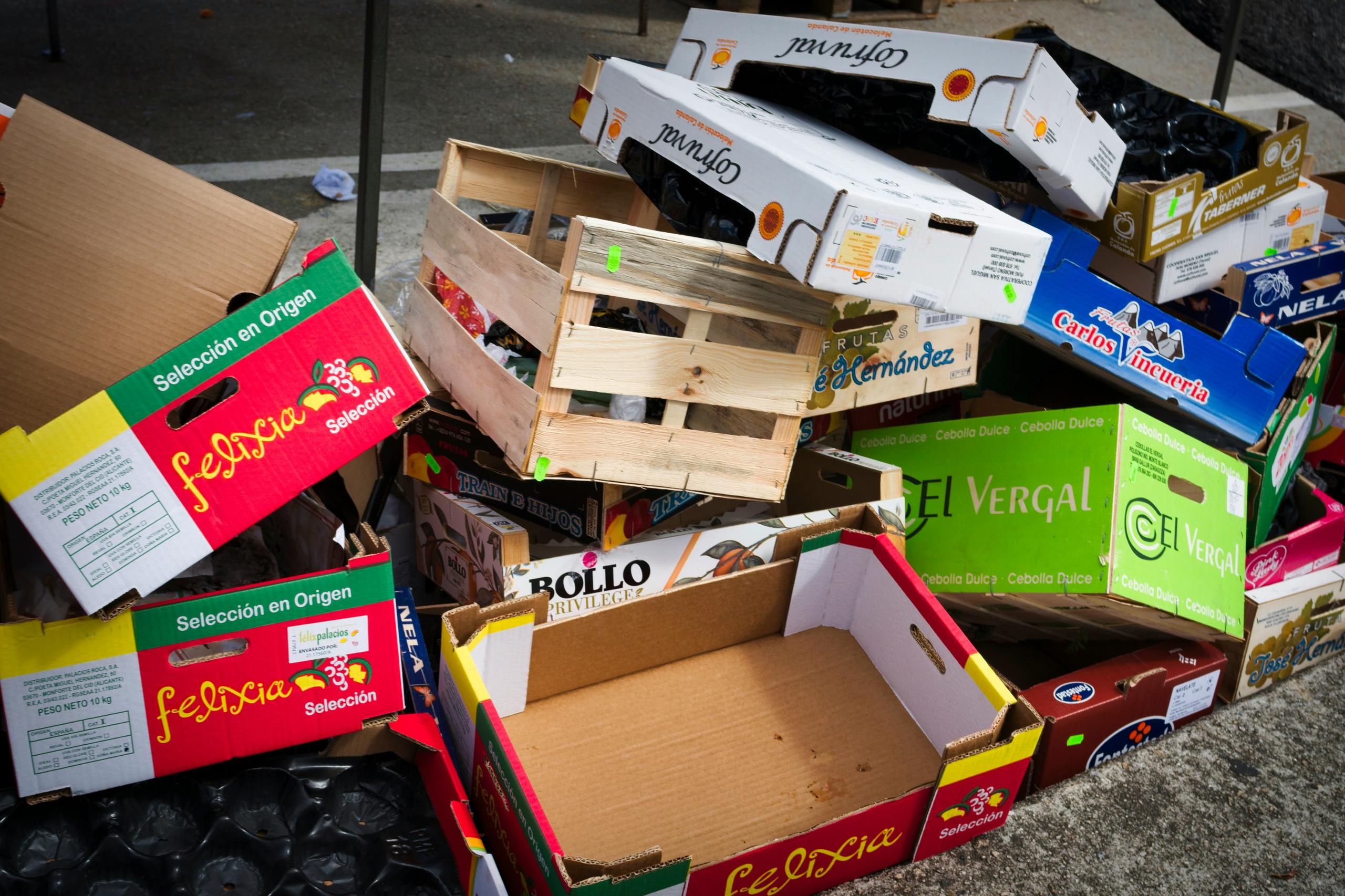 A pile of cardboard boxes and wooden crates