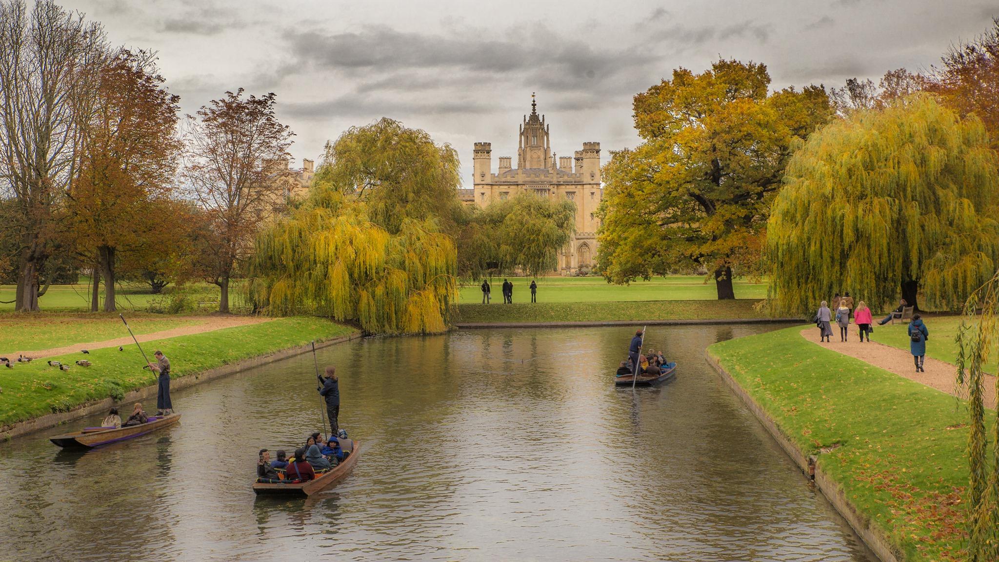 A landscape view of St John's College Cambridge from Trinty  College bridge with punts on the river in the foreground