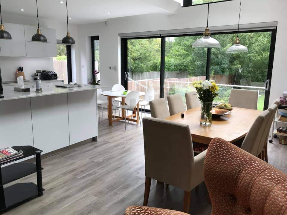 Tailored house extension open plan kitchen dining room with terrace view