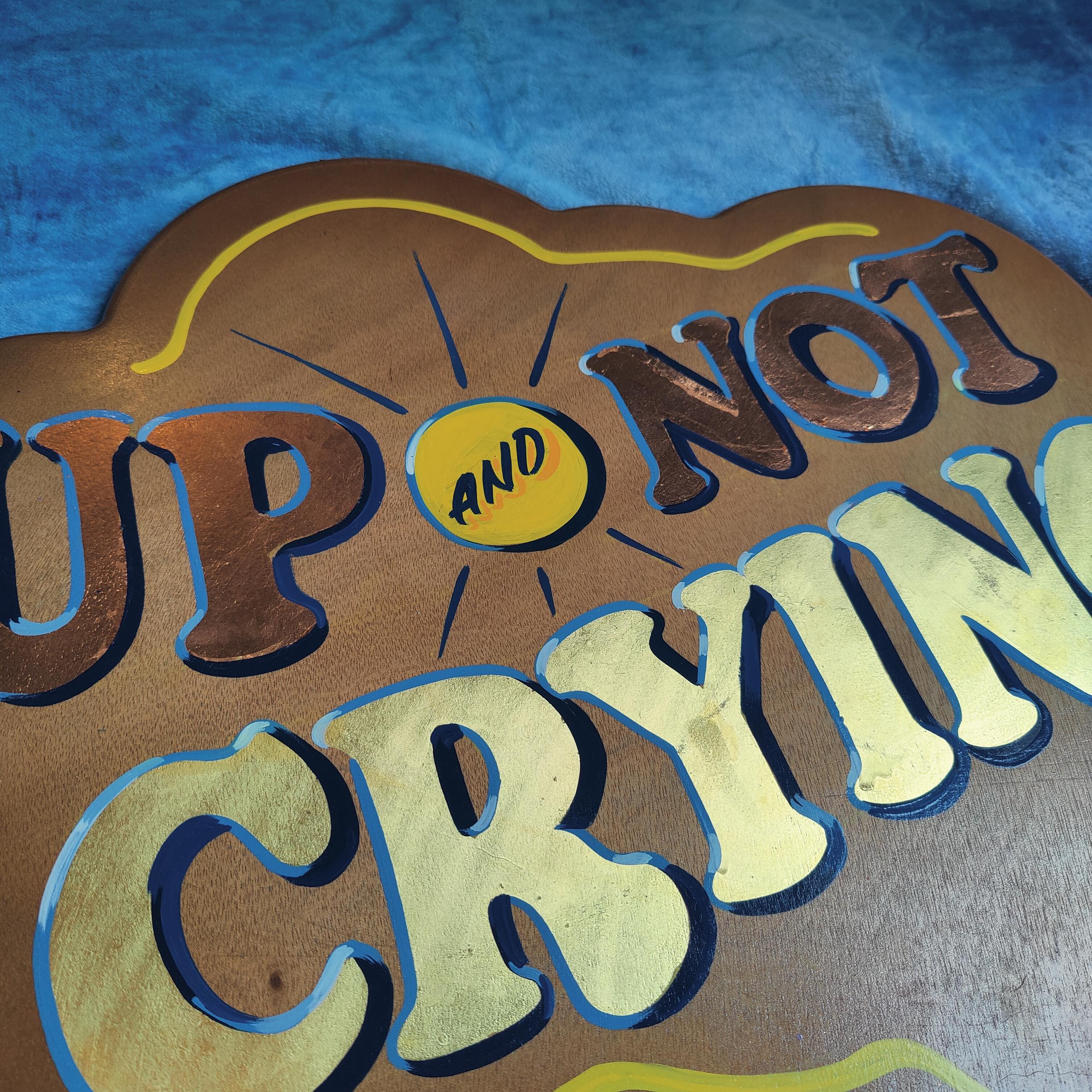 'UP & NOT CRYING' bevelled wooden panel with gold and copper leaf