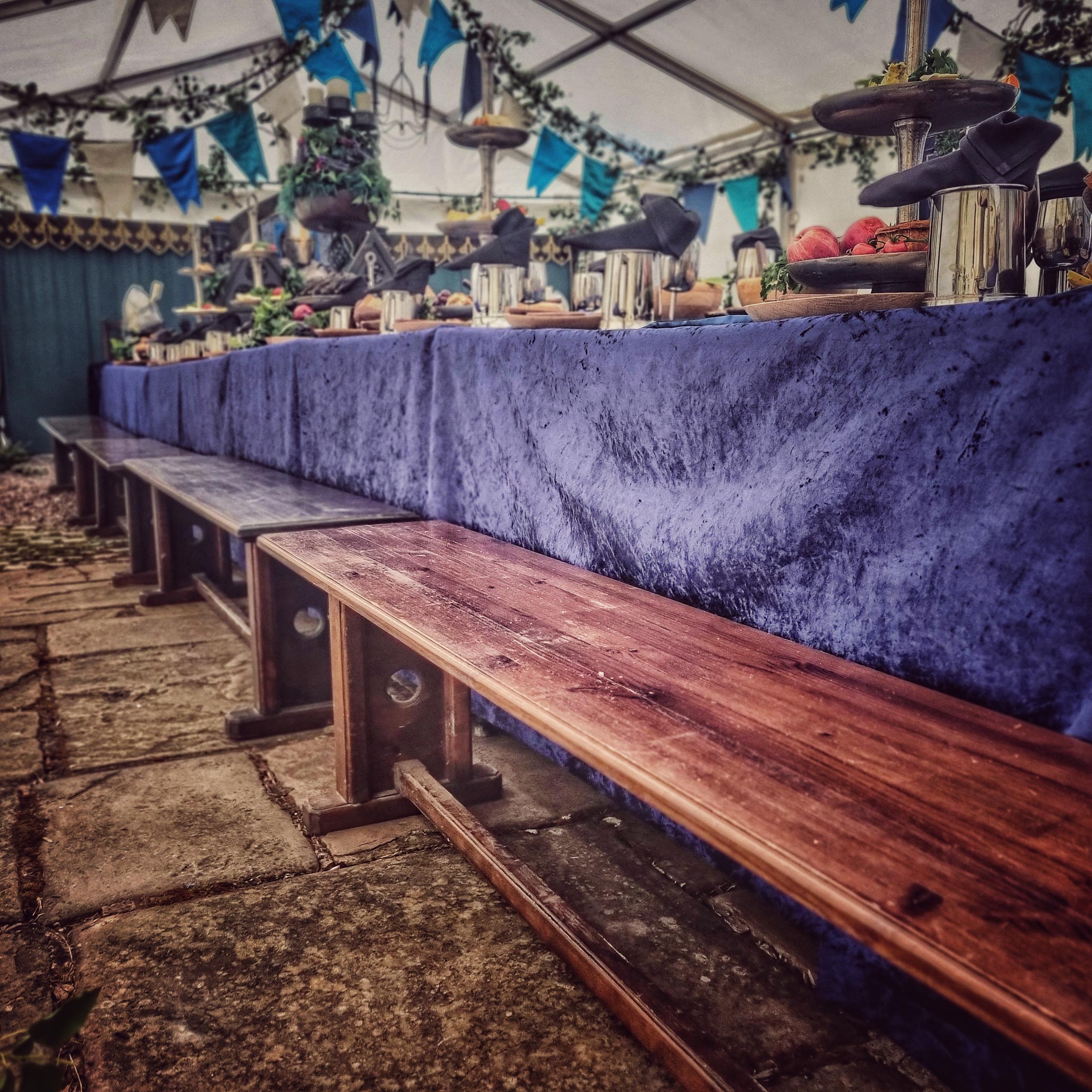 Wooden benches and blue velvet cloths