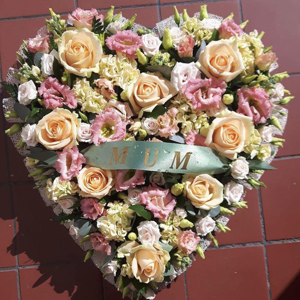 A funeral wreath from Flowers for You, Dalbeattie, using pink roses and lilies