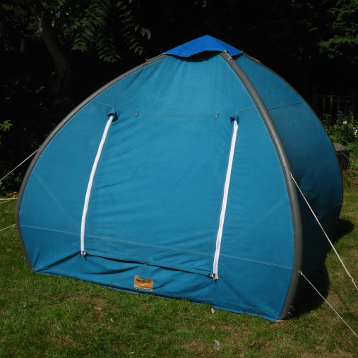 A 1950 Igloo Inflatable (Air) Tent in blue pitched in a field