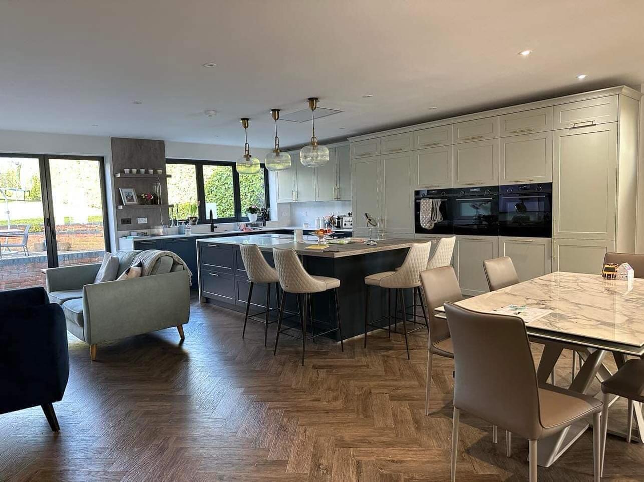 Open plan kitchen dining area with entrance from garden , modern design