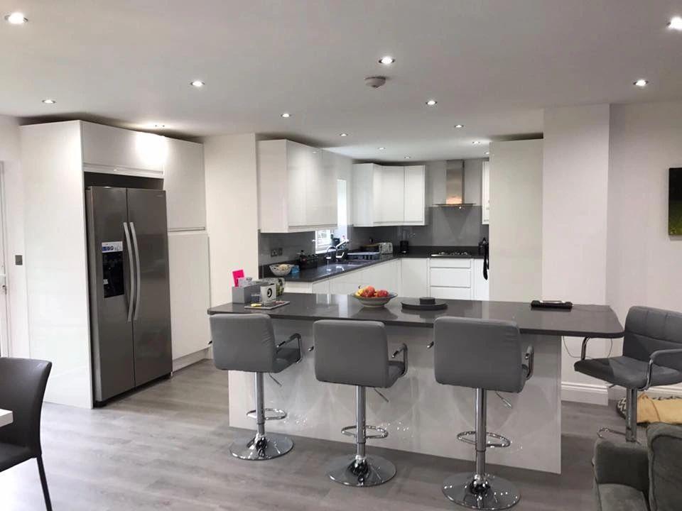 Beautiful kitchen and dining area , white and grey combination