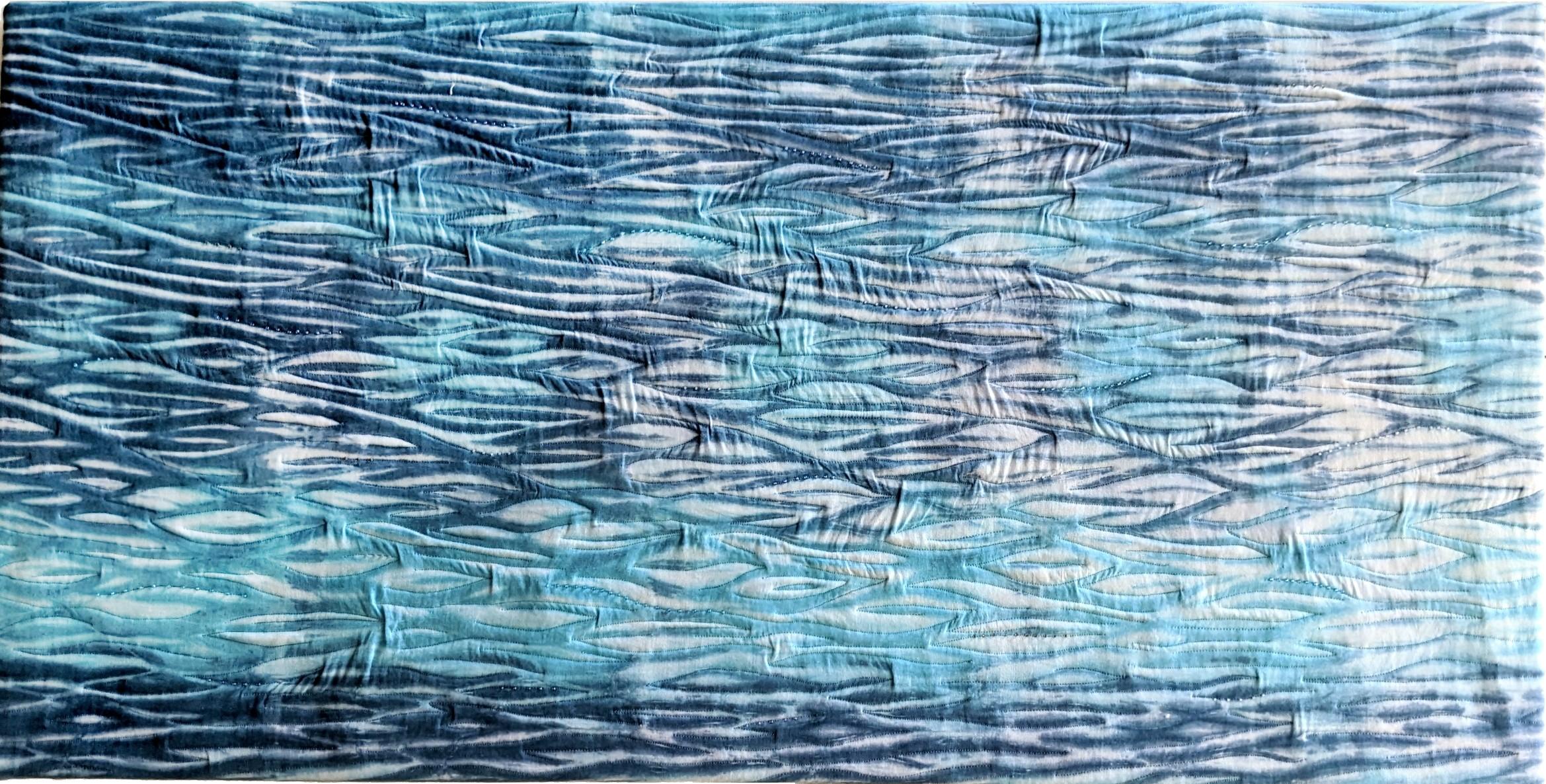 Shibori dyed fabric with machine quilting and beads. 52 x 104cm