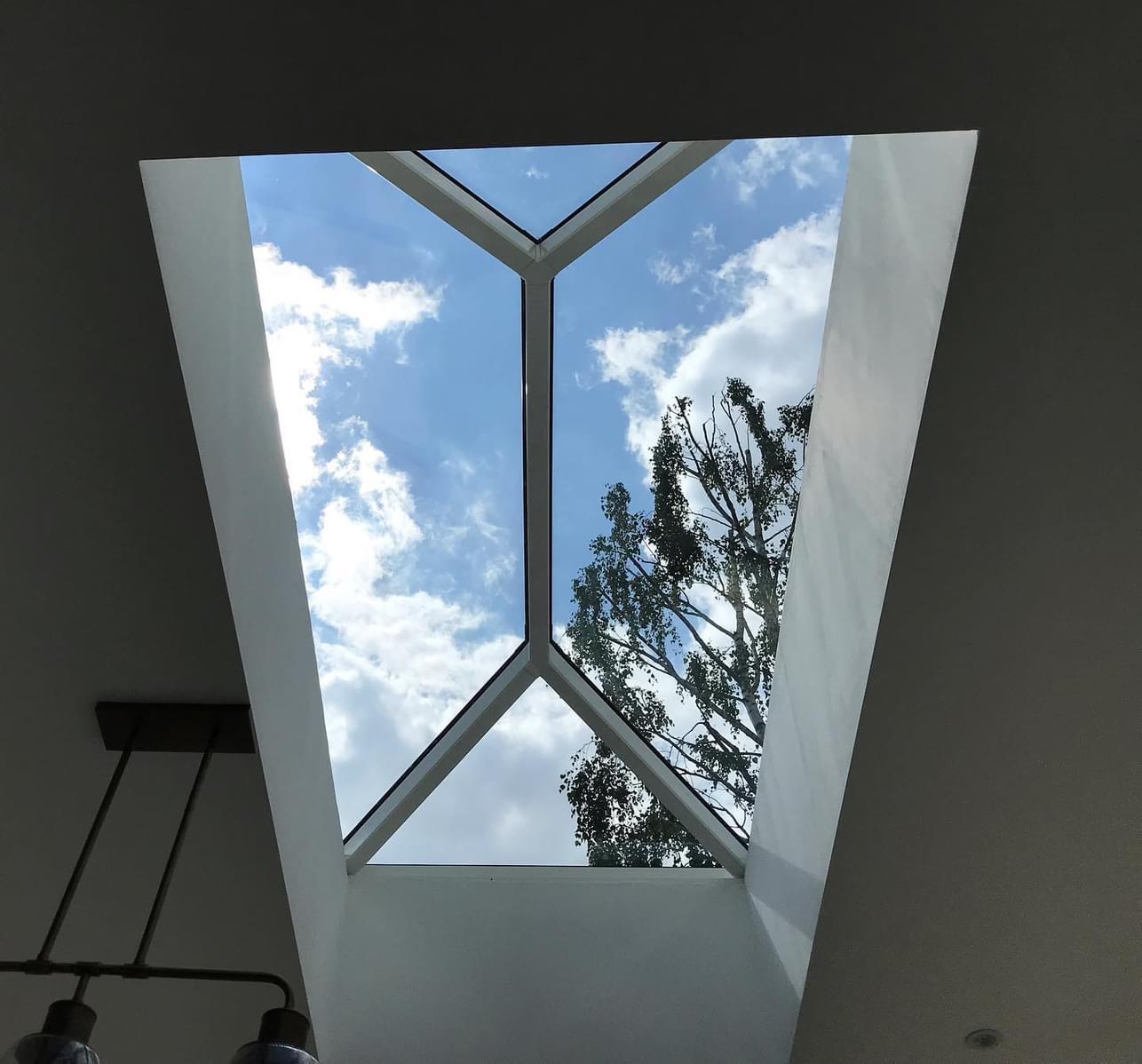 Stunning loft conversion featuring expansive glass ceilings, flooding the space with natural light