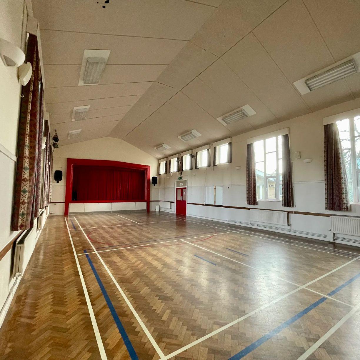 Interior of a village hall facing a stage
