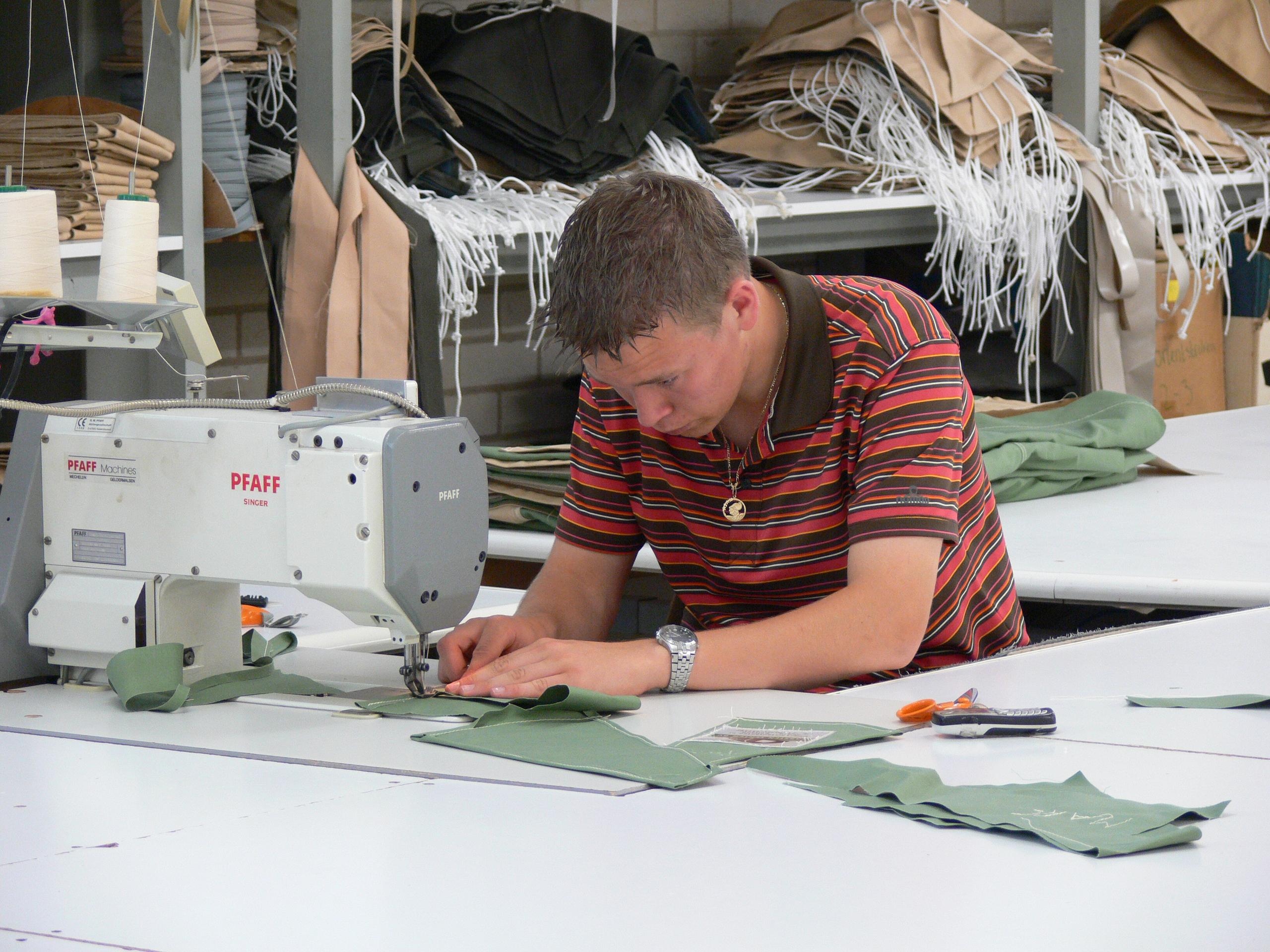 Person at modern day sewing machine making tents