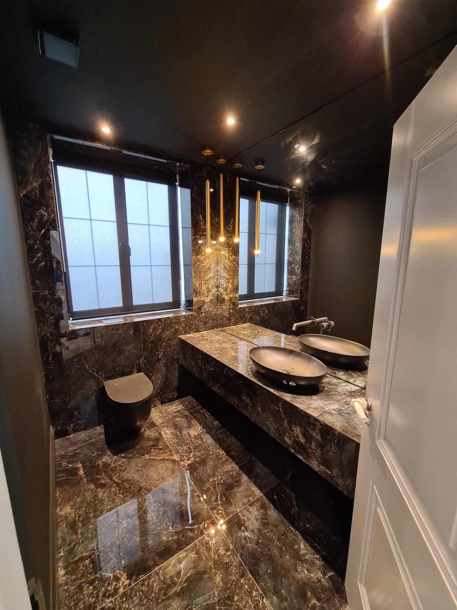 Bathroom renovation created using dark and light dark colours