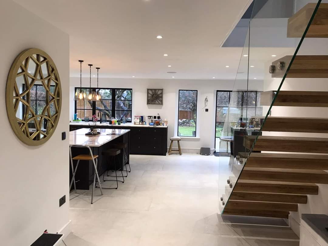 Open plan kitchen dining area renovation , wood and glass stairs leading to first floor