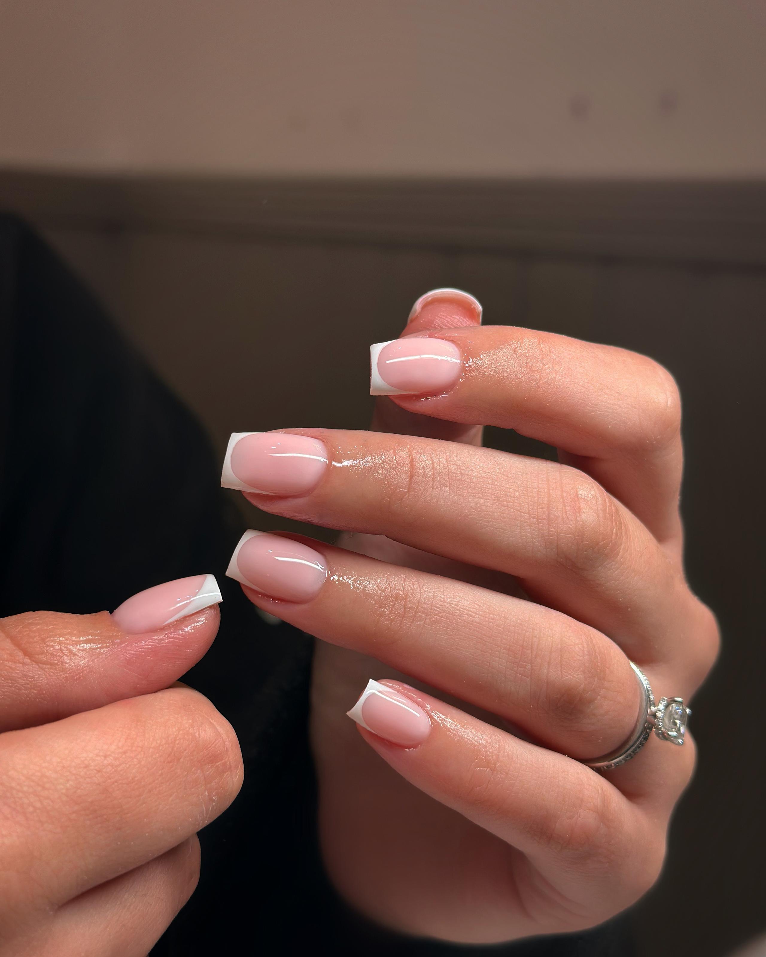 The Glam Angel - A picture of a hand with freshly painted red nails