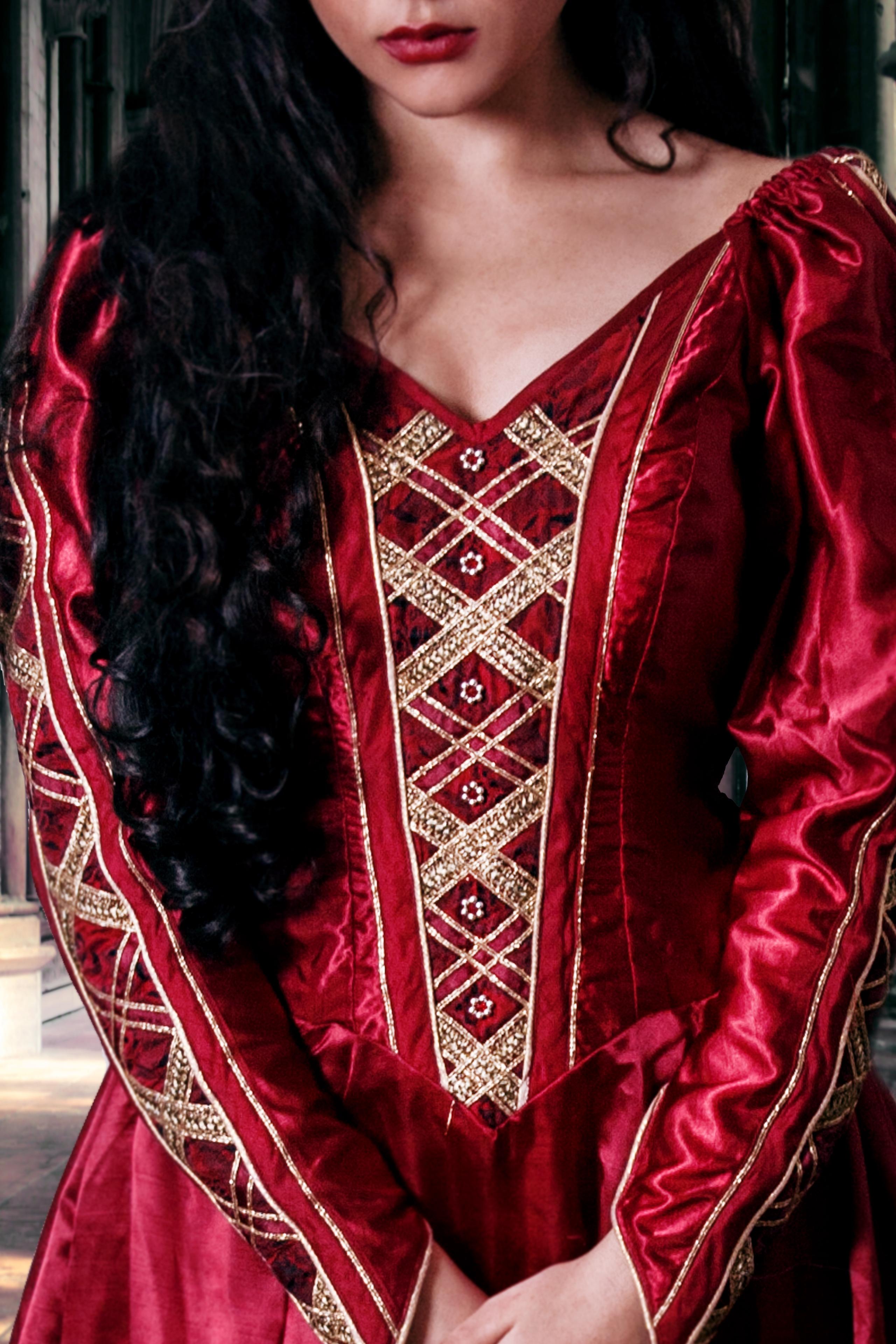 Red medieval gown with criss cross ribbon on the front and beading
