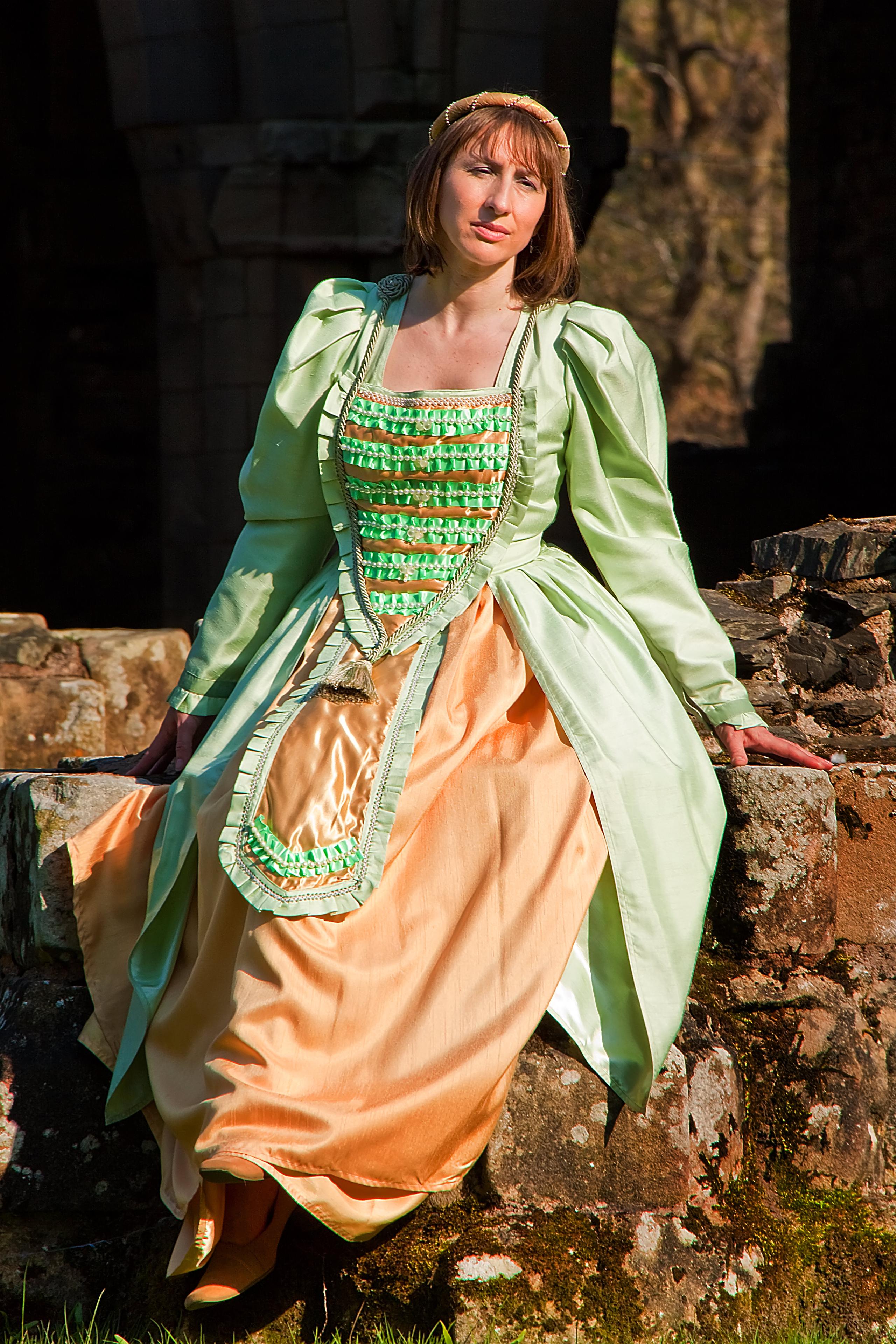Mint green medieval gown to hire with gold full skirt and medium pearl beads