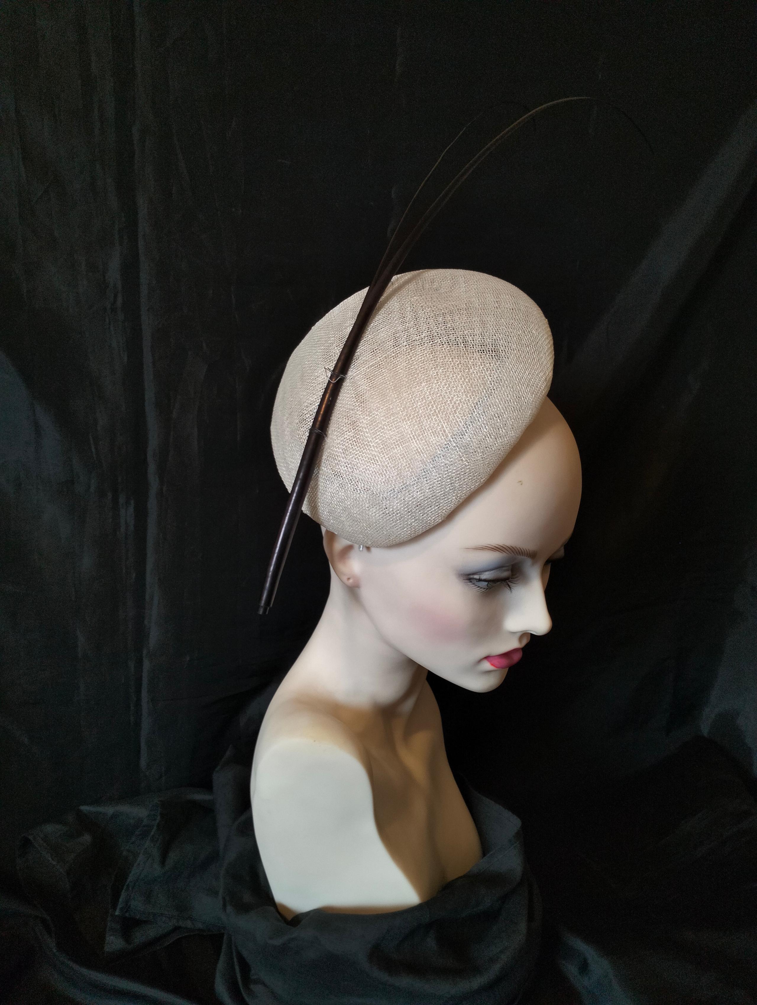 This stunning, hand blocked sinamay beret is trimmed with two long black quills.