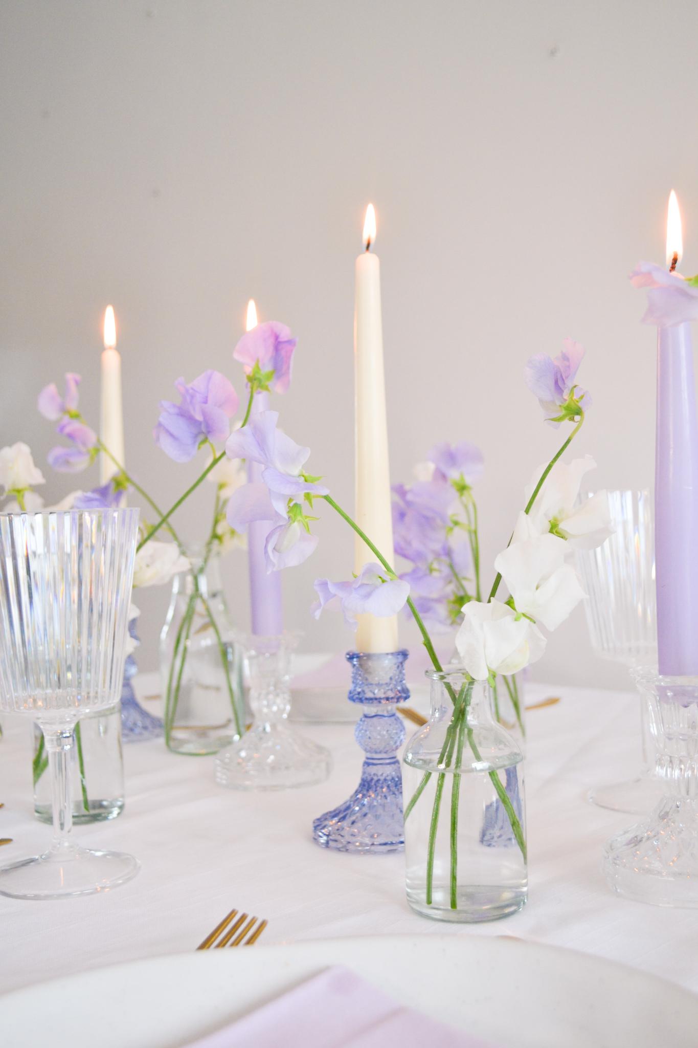 Lilac and white sweet pea table setting with tapered candles